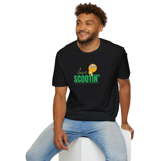 Black scootin graphic tee with green text and emoji worn by smiling man sitting on white block