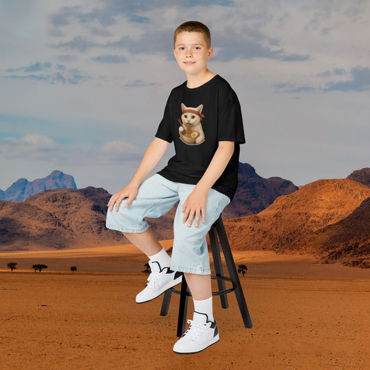 Boy wearing mashafrica style Noodle Ninja Cat T-shirt in black sitting on a stool in desert background