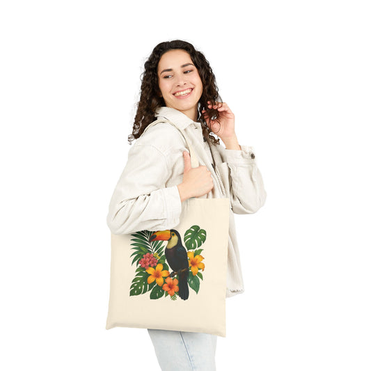 Woman carrying a mashafrica-style toucan print bag with tropical floral design on beige canvas